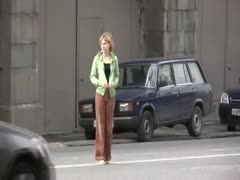 A cute little Russian playgirl gets dressed outside.